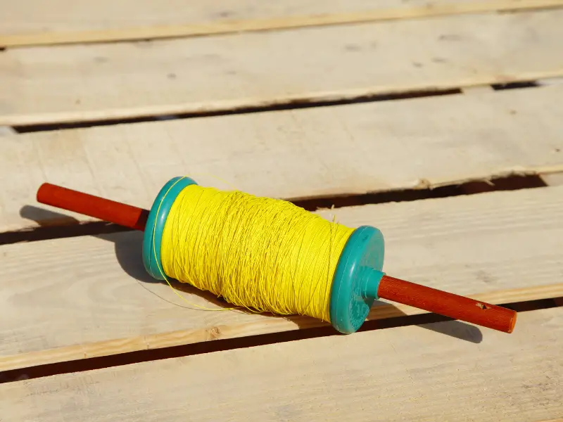 Bright yellow kite line on a spool